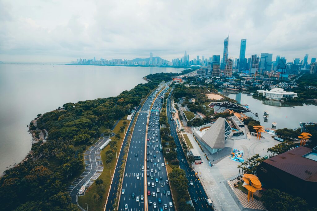 Stunning aerial view of a bustling highway and urban skyline in Shenzhen, China.